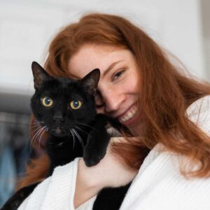cheerful-woman-hugging-cat-at-home-2022-03-04-05-53-51-utc.jpg